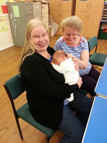Picture of Annabel and Anne giving Stanley a cuddle