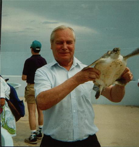 Picture of Annabel's Dad holding a turtle (on holiday in the Caymen Islands)